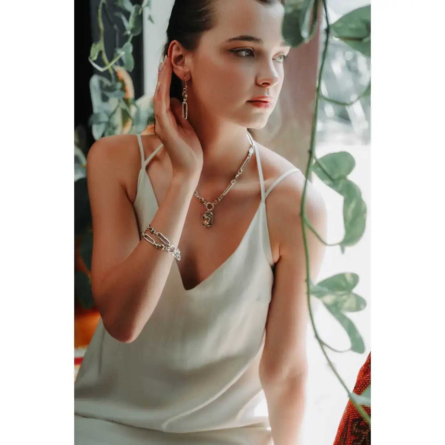 Model showcasing Maple Rose jewelry with 925 silver plating and Swarovski crystals.